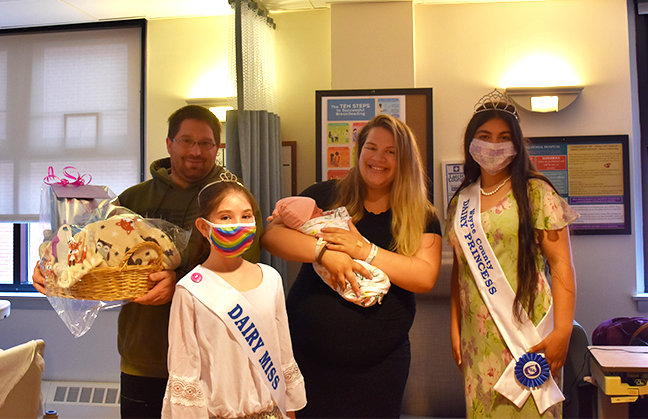 Wayne County Dairy Princess Elektra Kehagias and Dairy Miss Zoey Tyler welcomed Adelin Hendrickson, the first baby born in June, National Dairy Month. Pictured are Kevin Hendrickson, left; Zoey Tyler; Katelin Dennis, holding Adelin; and Elektra Kehagias...